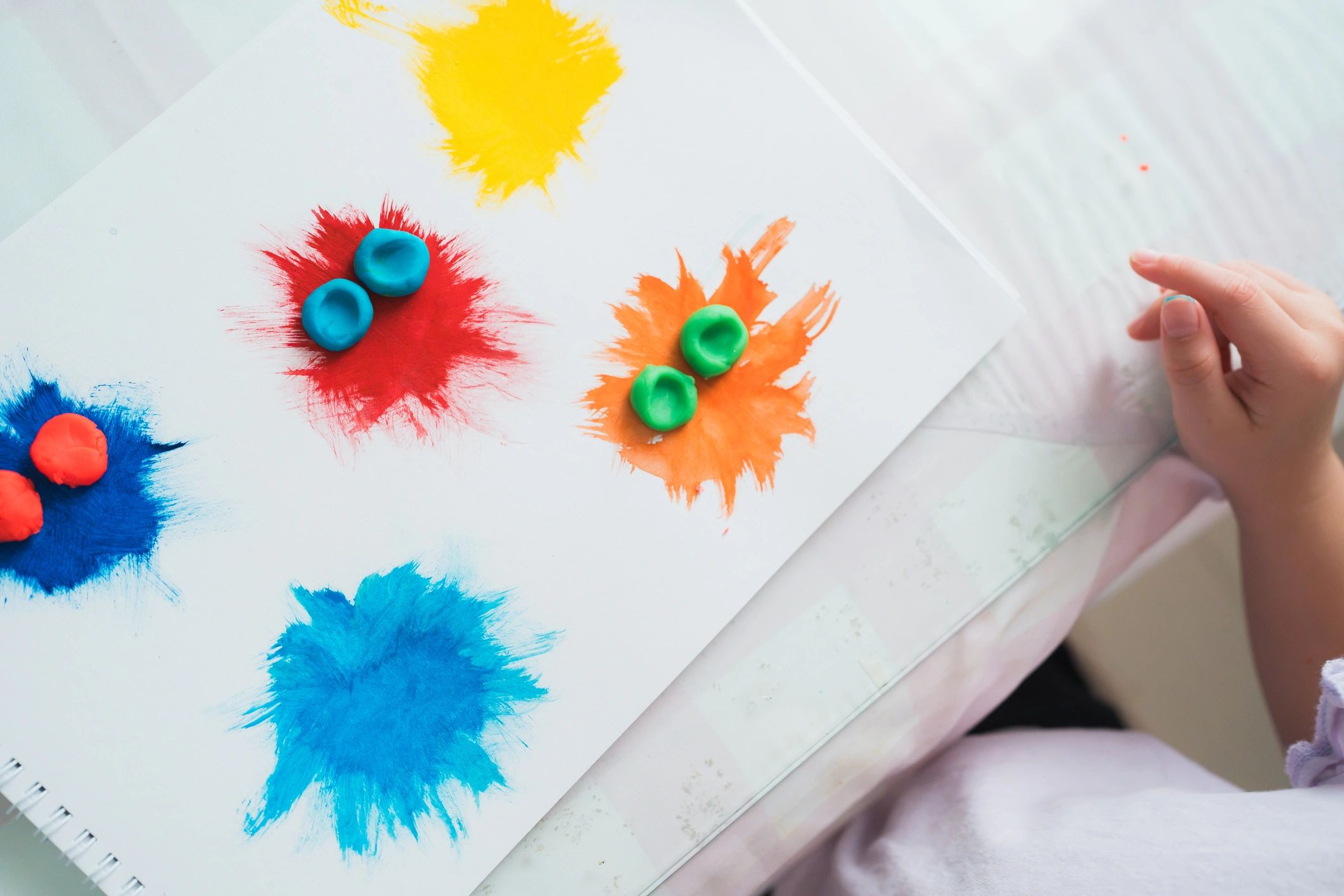 Child developing fine motor skills with playdough